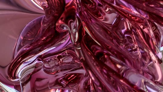 Extreme close-up of twisted ruby and magenta glass