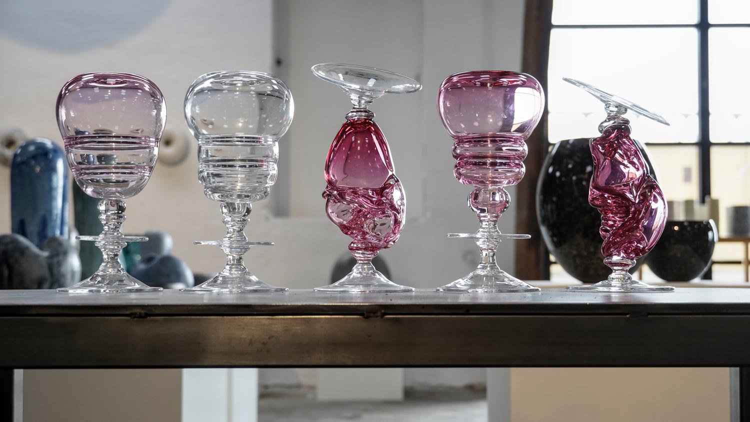 A row of the vases on a studio shelf in window light