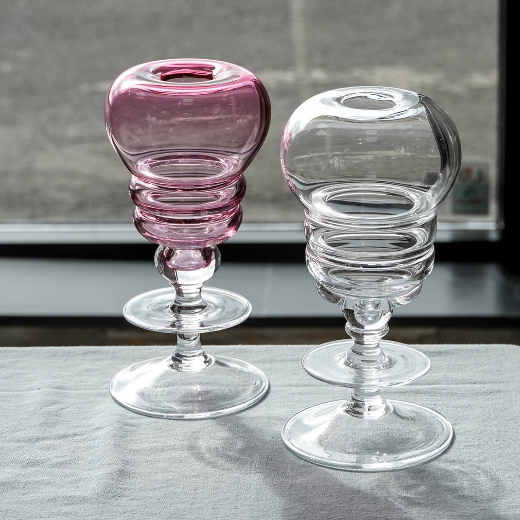 Two footed vases, one cranberry and one clear, with banded bowls