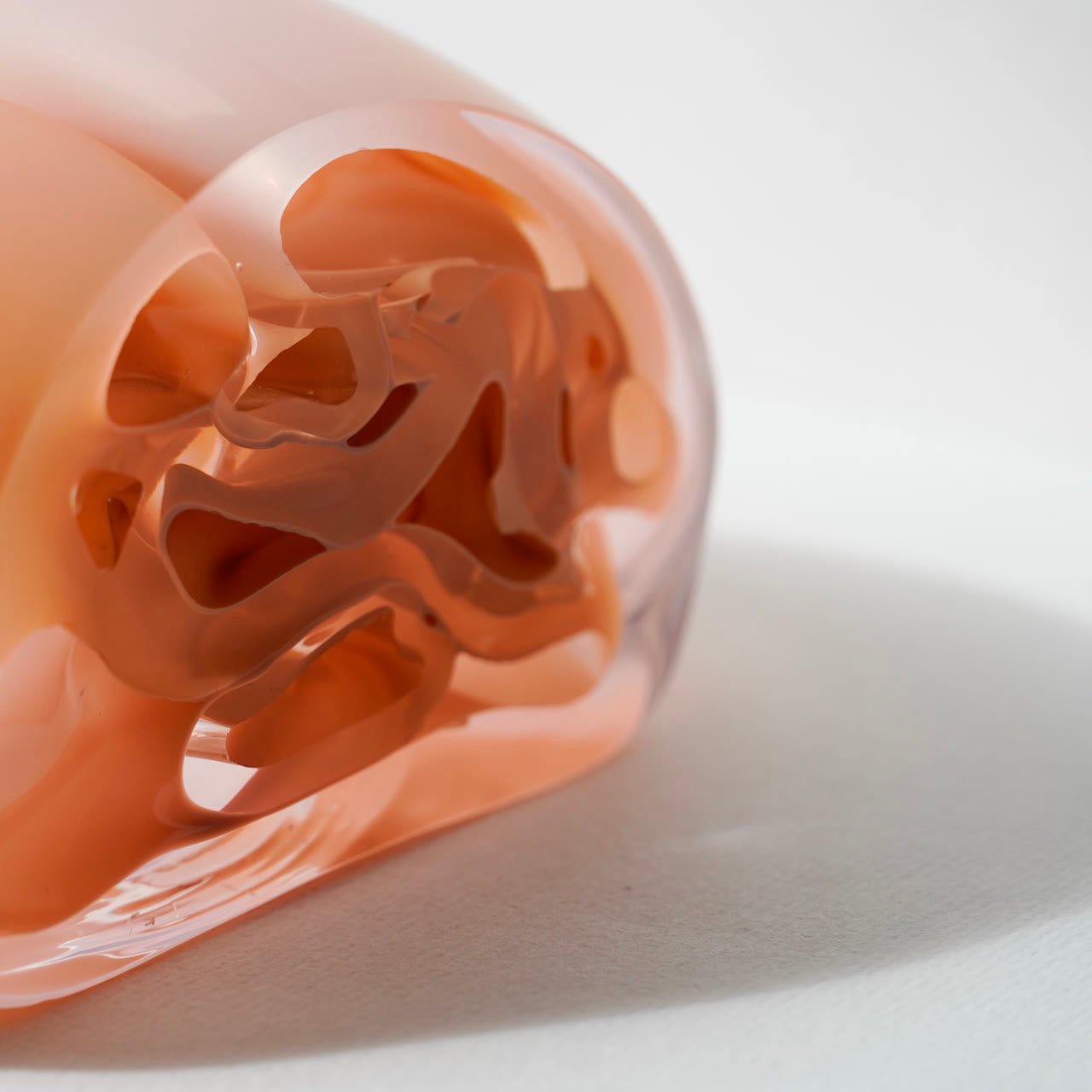 The form lit from the side, its interior cavity in shadow